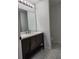 Bathroom featuring a dark wood vanity with a bright countertop and modern fixtures at 541 56Th Ct, Ocala, FL 34482
