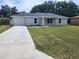 Charming one-story home with a well-manicured lawn and a concrete driveway at 541 56Th Ct, Ocala, FL 34482