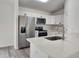 Modern kitchen featuring white cabinets, quartz countertops, and stainless steel appliances at 541 56Th Ct, Ocala, FL 34482