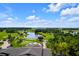 Scenic aerial shot of golf course with a tranquil pond and fountain under a blue sky with clouds at 6051 Sw 93Rd Cir, Ocala, FL 34481