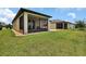 Expansive backyard with green grass, a screened patio, and well-kept grounds for outdoor activities at 6051 Sw 93Rd Cir, Ocala, FL 34481