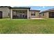 Spacious backyard with a green lawn, a screened patio, and manicured landscaping, great for entertaining at 6051 Sw 93Rd Cir, Ocala, FL 34481