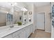 Well-lit bathroom with double sinks, a large mirror, and a shower and tub at 6051 Sw 93Rd Cir, Ocala, FL 34481