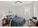 Inviting bedroom with a ceiling fan, natural light, and a cozy ambiance, ideal for relaxation at 6051 Sw 93Rd Cir, Ocala, FL 34481