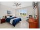 Relaxing bedroom features a comfortable bed, dresser, and a large window with a peaceful backyard view at 6051 Sw 93Rd Cir, Ocala, FL 34481