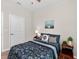 Comfortable bedroom with a decorative painting and a side table lamp, perfect for unwinding at 6051 Sw 93Rd Cir, Ocala, FL 34481