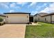 Well-maintained home featuring an attached two-car garage and a screened-in porch at 6051 Sw 93Rd Cir, Ocala, FL 34481