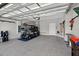 Spacious garage features epoxy floors, ample storage racks, and a convenient golf cart for added leisure at 6051 Sw 93Rd Cir, Ocala, FL 34481