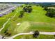 Beautiful aerial view of a lush golf course with manicured greens and winding cart paths in a lovely community at 6051 Sw 93Rd Cir, Ocala, FL 34481
