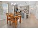 Bright kitchen and dining area boasts stainless steel appliances and a stylish center island with seating at 6051 Sw 93Rd Cir, Ocala, FL 34481