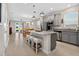 Open kitchen with an island, stainless steel appliances, gray cabinets and bar stool seating at 6051 Sw 93Rd Cir, Ocala, FL 34481