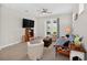 Comfortable living room offers tile floors, recessed lighting, and views of the backyard through sliding doors at 6051 Sw 93Rd Cir, Ocala, FL 34481