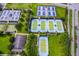 Aerial view of community tennis, pickleball, and bocce ball courts surrounded by lush landscaping at 6051 Sw 93Rd Cir, Ocala, FL 34481
