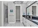 Bathroom featuring double vanity with dark countertops and a walk-in shower at 7210 Sw 179 Ct, Dunnellon, FL 34432