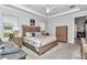Comfortable bedroom featuring a ceiling fan, beach decor and ensuite bathroom entrance at 7210 Sw 179 Ct, Dunnellon, FL 34432