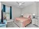 Comfortable bedroom featuring a white bed frame, bedside tables, and natural light from the window at 7210 Sw 179 Ct, Dunnellon, FL 34432