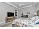 Bright bedroom with tray ceilings featuring a workspace, beach decor, and an ensuite bathroom at 7210 Sw 179 Ct, Dunnellon, FL 34432