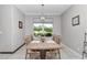 Light-filled dining room with a large window and seating for six at 7210 Sw 179 Ct, Dunnellon, FL 34432