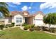 Charming single-story home with a terracotta tile roof and lush landscaping at 7210 Sw 179 Ct, Dunnellon, FL 34432