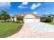 Inviting home with a red tile roof, three-car garage, and a lush green lawn at 7210 Sw 179 Ct, Dunnellon, FL 34432
