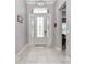 Inviting foyer with decorative front door and tile floors at 7210 Sw 179 Ct, Dunnellon, FL 34432