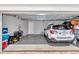 Clean garage with smooth concrete floors, featuring a white car and plenty of storage space at 7210 Sw 179 Ct, Dunnellon, FL 34432