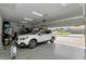 Spacious garage featuring epoxy floors, overhead storage, and an automatic door opener at 7210 Sw 179 Ct, Dunnellon, FL 34432