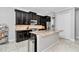 Well-equipped kitchen features dark cabinets, granite countertops, and stainless steel appliances at 7210 Sw 179 Ct, Dunnellon, FL 34432