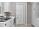 Functional laundry room with modern washer and dryer, complemented by white cabinets and ample storage at 7210 Sw 179 Ct, Dunnellon, FL 34432