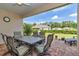 Relaxing covered patio featuring outdoor seating, perfect for enjoying serene views of the backyard at 7210 Sw 179 Ct, Dunnellon, FL 34432
