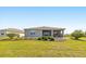 Manicured backyard with lush lawn, landscaping, and covered patio at 7750 Sw 87Th Ave, Ocala, FL 34481