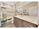 Bright bathroom featuring a vanity with storage, a large mirror, and a shower-tub combination with decorative tile at 7750 Sw 87Th Ave, Ocala, FL 34481
