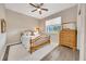 Cozy bedroom featuring a wooden bed frame, soft rug, and natural light from a window at 7750 Sw 87Th Ave, Ocala, FL 34481
