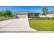Charming single-story home featuring a well-manicured lawn, a two-car garage, and a welcoming front entrance at 7750 Sw 87Th Ave, Ocala, FL 34481