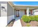 Charming front entrance featuring a red door, decorative shutters, and well-maintained landscaping, number 7750 at 7750 Sw 87Th Ave, Ocala, FL 34481