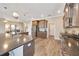 Well-equipped kitchen with a large island, stainless steel appliances, and wooden flooring at 7750 Sw 87Th Ave, Ocala, FL 34481