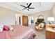 Spacious main bedroom boasts a walk-in closet, a TV, and comfortable seating for relaxation at 7750 Sw 87Th Ave, Ocala, FL 34481