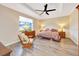 Serene main bedroom with a tray ceiling, a ceiling fan and a large window providing natural light at 7750 Sw 87Th Ave, Ocala, FL 34481