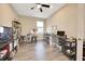 Well-lit home office with dual workstations, shelving, and wood-look flooring at 7750 Sw 87Th Ave, Ocala, FL 34481