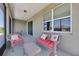 Cozy screened patio with wicker seating and view to outside at 7750 Sw 87Th Ave, Ocala, FL 34481