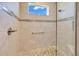 Modern walk-in shower featuring beautiful tile work, a rain shower head, and convenient grab bar at 7750 Sw 87Th Ave, Ocala, FL 34481