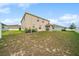 Large backyard with lawn, landscaping, and covered patio at 8110 Sw 59Th Ter, Ocala, FL 34476