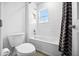 Clean bathroom featuring a shower-tub combo with white tile and a polka dot shower curtain at 8110 Sw 59Th Ter, Ocala, FL 34476