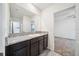 Bathroom with dark cabinets, granite countertop, and a view into the adjacent bedroom at 8110 Sw 59Th Ter, Ocala, FL 34476