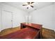 An empty bedroom features neutral walls and flooring, ceiling fan, and a double door closet at 8110 Sw 59Th Ter, Ocala, FL 34476
