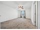 A light filled bedroom featuring neutral carpet, ceiling fan, and a window providing natural light at 8110 Sw 59Th Ter, Ocala, FL 34476