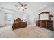 This bright bedroom features a ceiling fan and a large wood dresser at 8110 Sw 59Th Ter, Ocala, FL 34476
