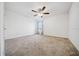 A bright bedroom featuring a ceiling fan, neutral carpet, and a sunlit window at 8110 Sw 59Th Ter, Ocala, FL 34476