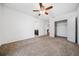 An inviting bedroom with plush carpet, ceiling fan, and access to an ensuite bathroom and walk-in closet at 8110 Sw 59Th Ter, Ocala, FL 34476