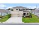Two-story home showcasing manicured landscaping, a two-car garage, and an inviting front porch at 8110 Sw 59Th Ter, Ocala, FL 34476